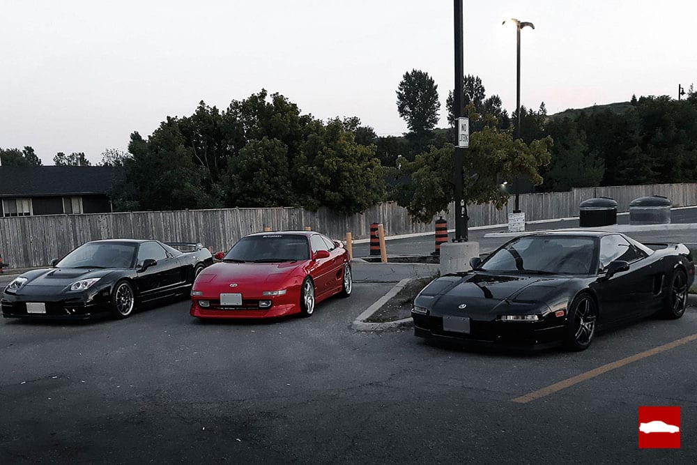 Toyota MR2 surrounded by Acura NSXs