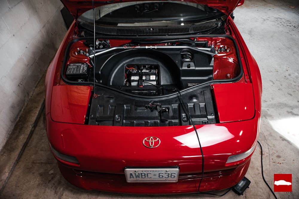 Red MR2 with battery tender connected