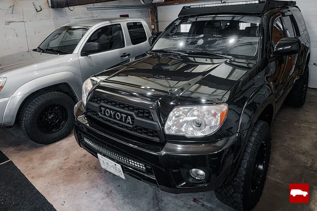 Toyota 4runner and Tacoma parked in garage