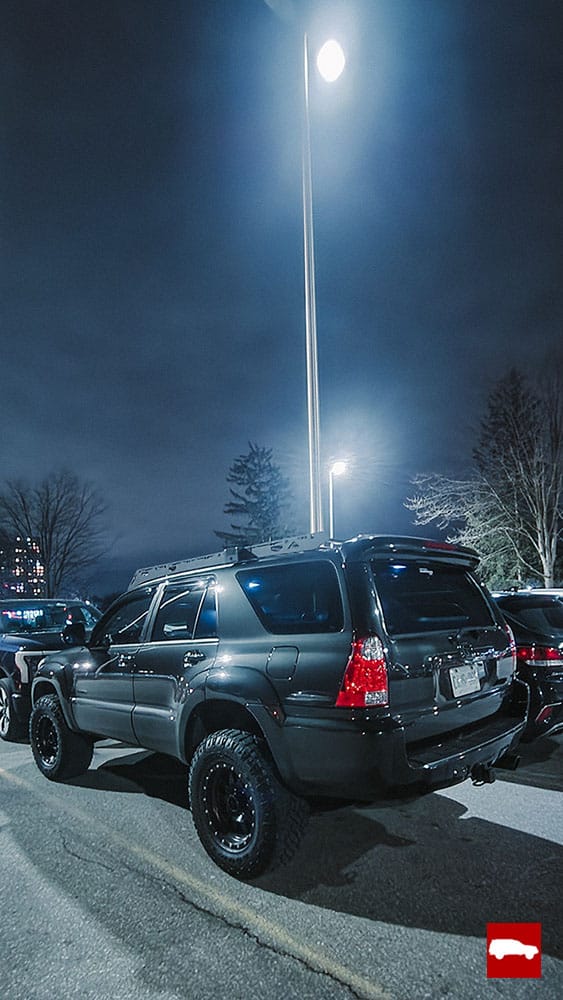 4Runner parked under bright lights at night time
