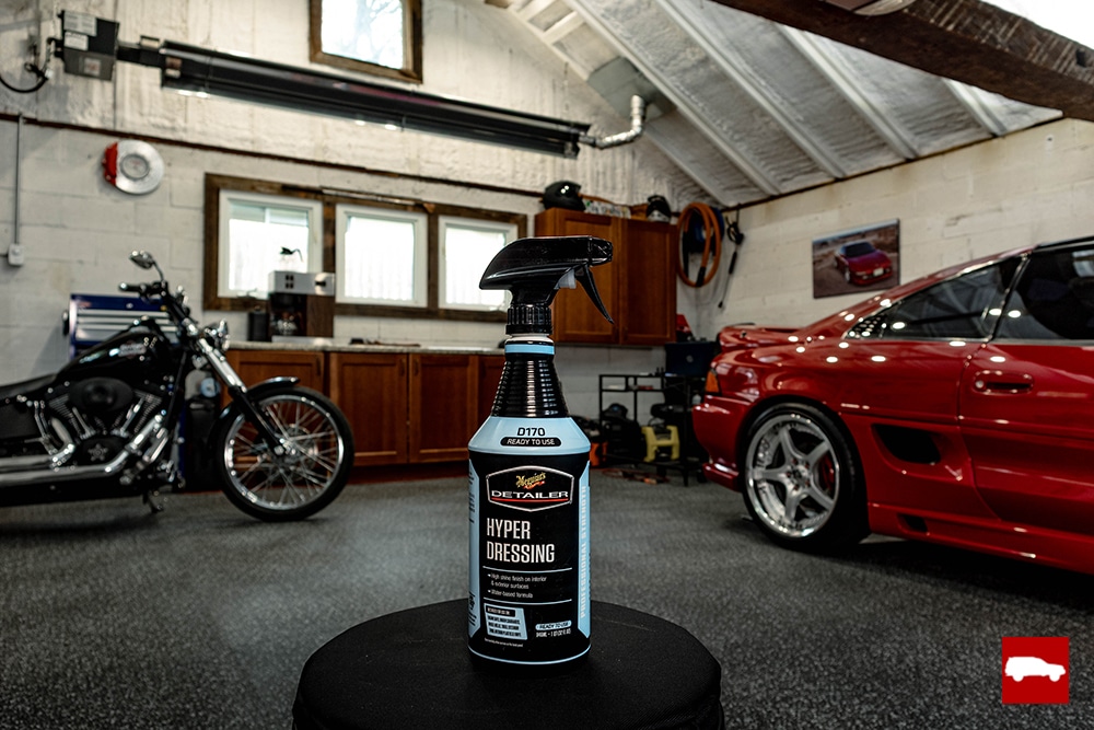 A bottle of tire dressing on a stool in a garage