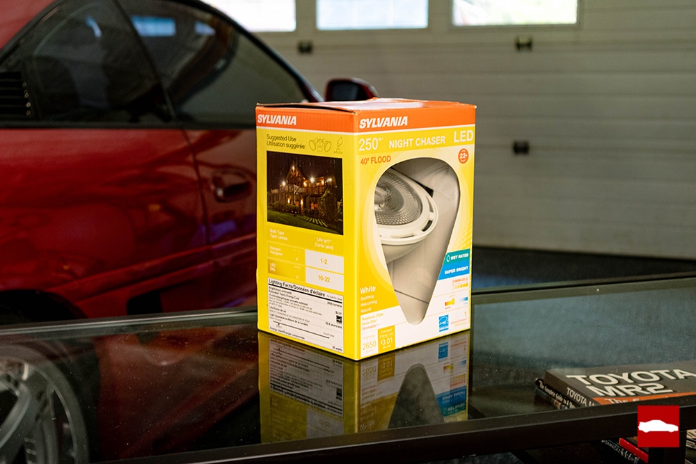 LED bulb used for paint correction in a box in front of red MR2