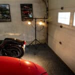 A stand holding 2 LED lights used for paint correction in a garage