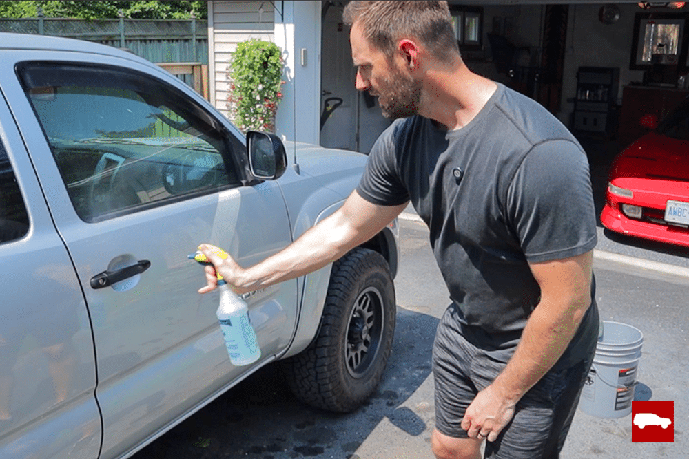 Spraying Optimum No Rinse on truck door