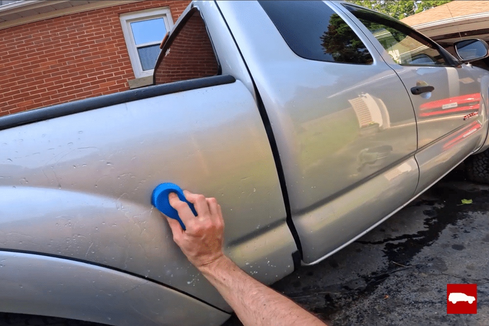 Using a Nanoskin Autoscrub clay sponge on a Tacoma bedside